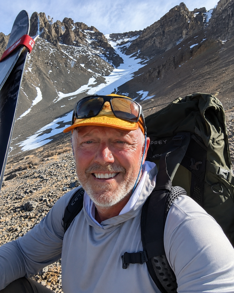 Josh Smith, founder of Pathfinder Learning, with outdoor gear in the mountains